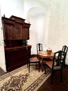 a room with a table and chairs and a cabinet at Csaky Palace Bratislava in Bratislava
