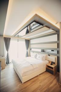 Postel nebo postele na pokoji v ubytování Burhaniye Marina Boutique Hotel