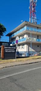 a building on the side of a road next to a street at Apartamenty Neptun in Świnoujście