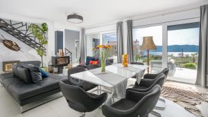 a living room with a couch and a table and chairs at Villa Alma Krk in Krk