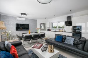 a living room with a couch and a table at Villa Alma Krk in Krk