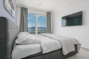 a bedroom with a bed and a large window at Villa Alma Krk in Krk +40 photos
