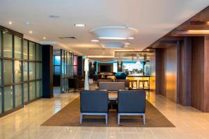 an office lobby with a table and chairs at AC Hotel by Marriott Birmingham in Birmingham