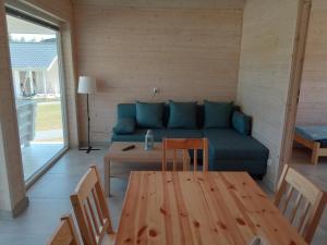 a living room with a couch and a table at Zante Sarbinowo in Sarbinowo +23 photos