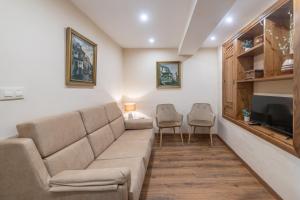un soggiorno con divano e 2 sedie di Pría, apartamento en Ribadesella a Ribadesella