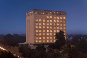 a tall building with many windows at night at Courtyard by Marriott Amritsar in Amritsar