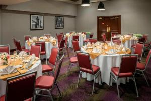 a room with tables and chairs in a room at Four Points by Sheraton Boston Logan Airport Revere in Revere