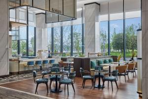 a rendering of a restaurant with tables and chairs at Sheraton Chengdu Pidu in Chengdu