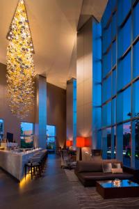 a lobby of a building with a chandelier at The Westin Guadalajara in Guadalajara