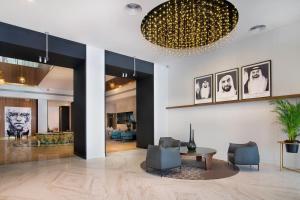 a lobby with a table and chairs and a living room at Le Meridien Abu Dhabi in Abu Dhabi +37 photos