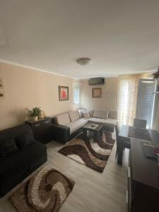 a living room with a couch and a table at Studio Apartment for rent in Budva in Budva
