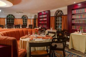 a restaurant with tables and couches and chairs at Protea Hotel by Marriott Blantyre Ryalls in Blantyre