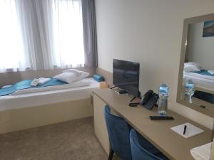 Posteľ alebo postele v izbe v ubytovaní Garni Hotel IMPERIUM Subotica