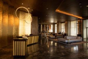 a lobby with couches and a chandelier at JW Marriott Hotel Guadalajara in Guadalajara