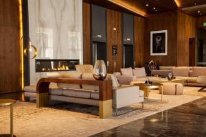 a living room with couches and a fireplace at JW Marriott Hotel Guadalajara in Guadalajara
