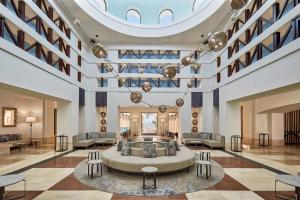 a lobby with a large couch in the middle at Sheraton Miramar Resort El Gouna in Hurghada