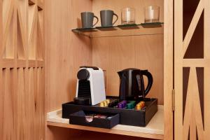 a coffee maker on a shelf in a cupboard at Sheraton Miramar Resort El Gouna in Hurghada