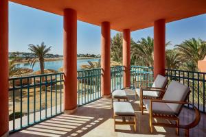 a balcony with chairs and a view of the water at Sheraton Miramar Resort El Gouna in Hurghada