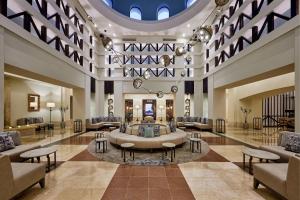 a lobby with couches and tables in a building at Sheraton Miramar Resort El Gouna in Hurghada
