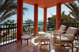 a balcony with chairs and a table and the ocean at Sheraton Miramar Resort El Gouna in Hurghada