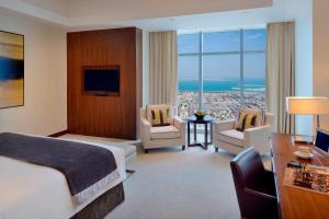 a hotel room with a bed and a desk at JW Marriott Marquis Hotel Dubai in Dubai