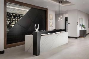 a lobby with a black and white counter and a wine cellar at Residence Inn by Marriott Bozeman Downtown in Bozeman