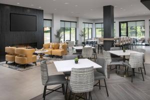 a restaurant with tables and chairs and a fireplace at Residence Inn by Marriott Bozeman Downtown in Bozeman