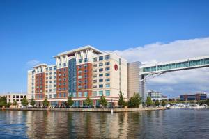 a large building next to a river with a bridge at Sheraton Erie Bayfront Hotel in Erie