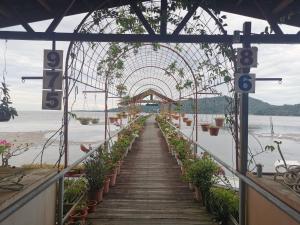 an archway with potted plants on a dock at Sandakan Sim Sim Homestay in Sandakan