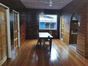 a dining room with a table and a window at Sandakan Sim Sim Homestay in Sandakan