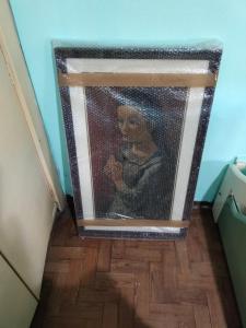a painting of a woman in a mirror in a room at LA MAGA in Remedios de Escalada