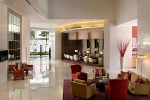 a lobby of a hotel with chairs and tables at Marriott Executive Apartments - Sukhumvit Park, Bangkok in Bangkok