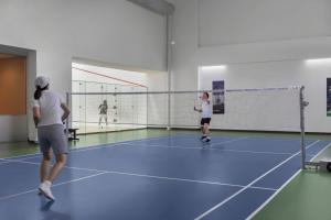 two people playing a game of volley ball on a court at Marriott Executive Apartments Sukhumvit Park, Bangkok in Bangkok