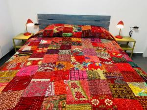 een kleurrijke quilt op een bed in een kamer bij קומותיים ברמה in Sha'al