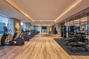 a gym with treadmills and elliptical machines at Courtyard by Marriott Changchun in Changchun