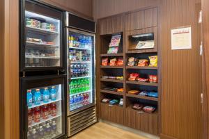 a refrigerator filled with lots of drinks and food at Fairfield Inn & Suites Des Moines West in West Des Moines