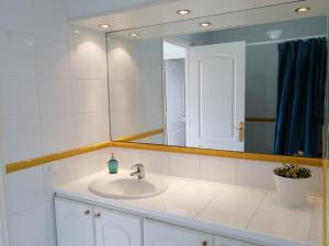 a bathroom with a sink and a mirror at Apartamento Costa Adeje - Orlando Complex in Adeje