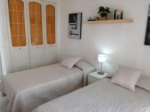 two beds sitting next to each other in a room at Apartamento Costa Adeje - Orlando Complex in Adeje