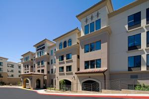 a large apartment building in a parking lot at SpringHill Suites by Marriott Valencia in Valencia