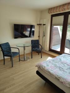 a bedroom with a bed and a table and chairs at Apartament w Juracie in Jurata