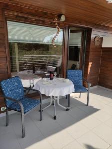 a table and two chairs on a porch with a table and chairs at Apartament w Juracie in Jurata