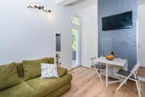 a living room with a couch and a table at Stunning apartment in quiet street near center With free parking 4 floor in Rijeka