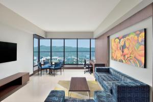 a living room with a couch and a table at Four Points by Sheraton Navi Mumbai, Vashi in Navi Mumbai