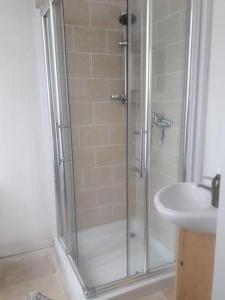 a shower with a glass door next to a sink at Vine maison 2 bedroom with ensuites in Saint-Julien-dʼEymet +12 photos