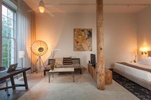 a bedroom with a bed and a table and a desk at Loft 523 in New Orleans