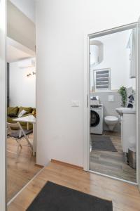 a bathroom with a door leading to a kitchen at Stunning apartment in quiet street near center With free parking 4 floor in Rijeka