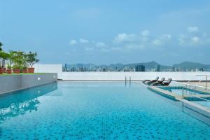 a swimming pool with a view of a city at Four Points by Sheraton Navi Mumbai, Vashi in Navi Mumbai