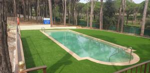 a swimming pool in a yard with green grass at Mas Vermey nº 10 in Palafrugell