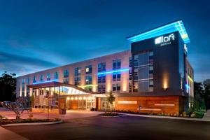 a hotel building with a lit up sign on it at Aloft Columbus Westerville in Westerville
