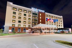 a front view of a hotel at night at Four Points By Sheraton Houston Energy Corridor in Katy
